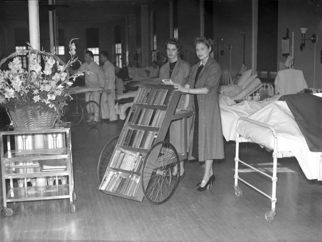 junior league volunteers with mobile library on MGH ward, 1938